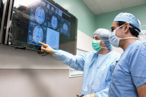 Dr. Leuthardt looks at a screen of a brain image