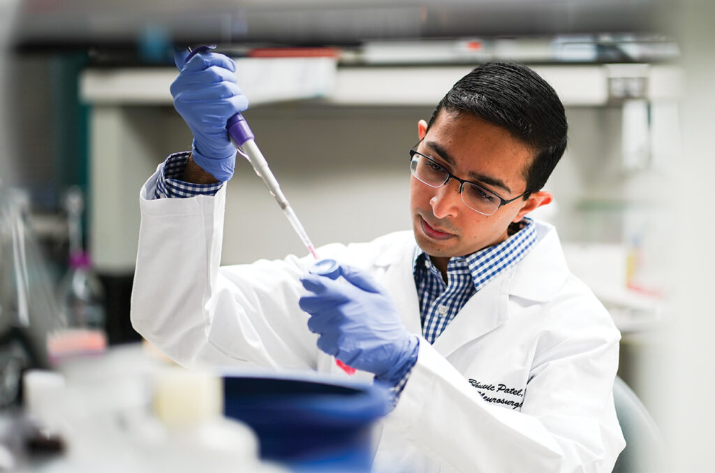 Bhuvic Patel, MD, performs a tumor dissociation in the lab of Albert H. Kim, MD, PhD.