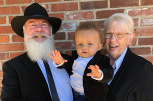 Bill and Jo Ann Trefts, pictured with grandson EJ, both lived with essential tremor for decades before being treated with deep brain stimulation.