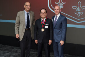 T.S. Park is honored by Dean Perlmutter and Dr. Gregory Zipfel.